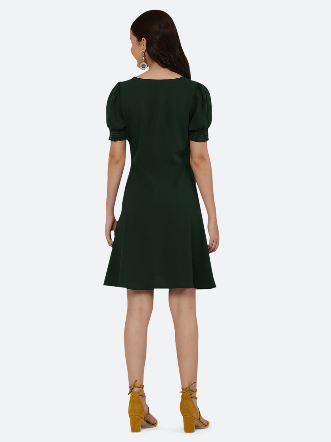 This dress features a circular hemline that adds a playful, flirty feel to the overall design. The ruched neckline and smocked sleeves add texture and dimension to the dress, while also providing a snug and comfortable fit. Perfect for summer days and breezy evenings, this dress is versatile and easy to wear, making it a must-have in your wardrobe.