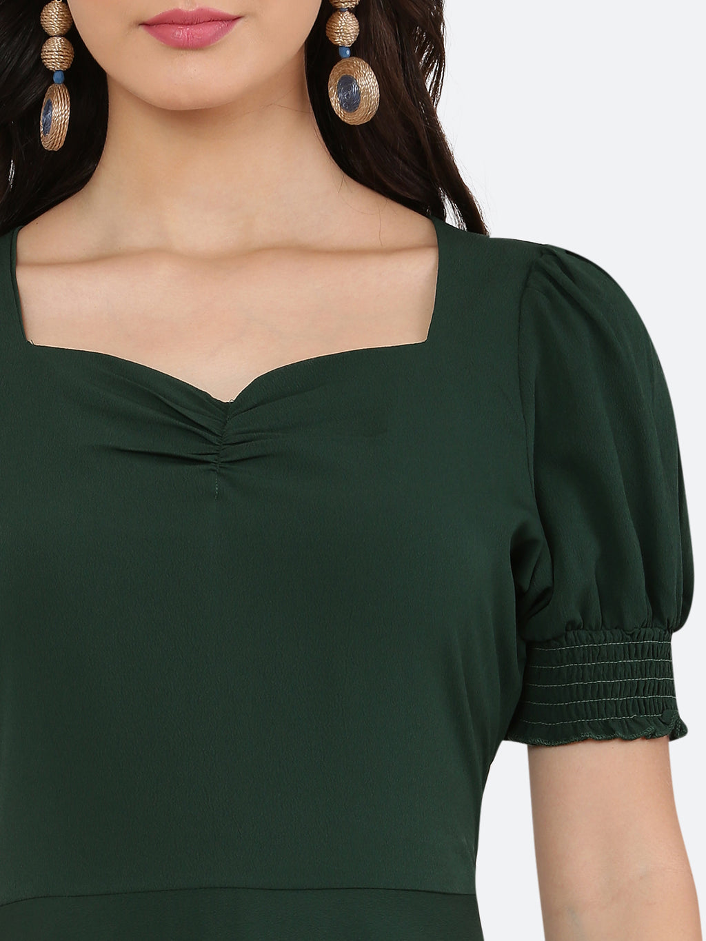 This dress features a circular hemline that adds a playful, flirty feel to the overall design. The ruched neckline and smocked sleeves add texture and dimension to the dress, while also providing a snug and comfortable fit. Perfect for summer days and breezy evenings, this dress is versatile and easy to wear, making it a must-have in your wardrobe.