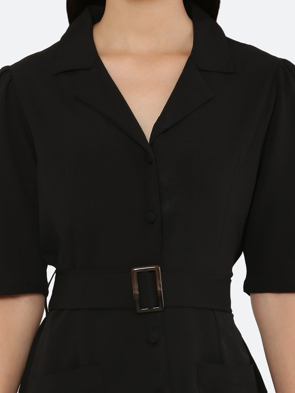 This short dress is the perfect combination of sophistication and style. The tailored collar adds a touch of elegance while the belt cinches in at the waist to create a flattering silhouette. The solid color makes it versatile and easy to pair with various accessories. Wear it to a summer barbecue or dress it up for a night out on the town. This dress is a must-have for any fashionista's wardrobe.