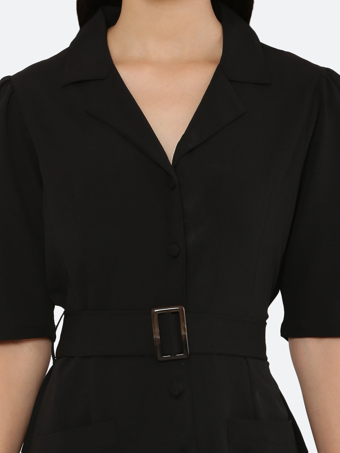 This short dress is the perfect combination of sophistication and style. The tailored collar adds a touch of elegance while the belt cinches in at the waist to create a flattering silhouette. The solid color makes it versatile and easy to pair with various accessories. Wear it to a summer barbecue or dress it up for a night out on the town. This dress is a must-have for any fashionista's wardrobe.