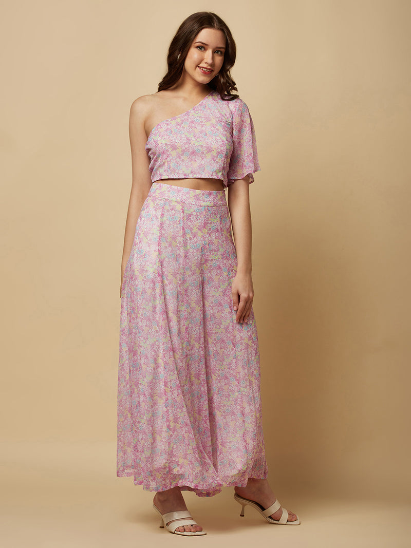 This fashionable co-ord set features a stunning purple floral print, making it the perfect addition to any fashion-forward woman's wardrobe. The set includes a trendy one-shoulder crop top and a pair of flowing palazzo pants.  The top is designed with a single shoulder strap, which adds an edgy and modern touch to the overall look. It also features a fitted bodice, which flatters the silhouette and accentuates the curves.
