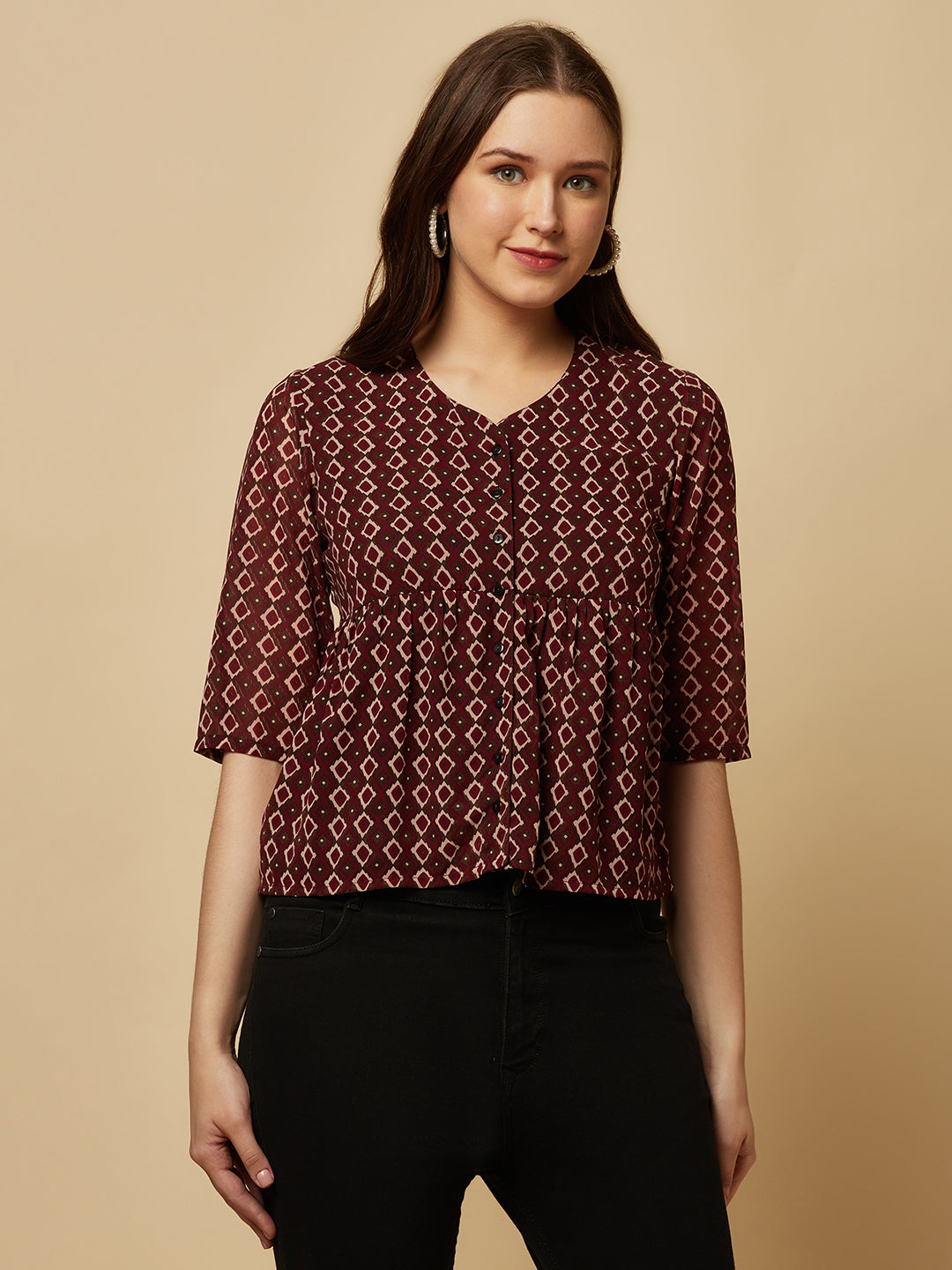A brown printed top with a front placket and ruched bust line is a stylish and elegant piece of clothing. The top has a simple and classic design with a front placket that adds a touch of sophistication to the outfit. The ruched bust line creates a flattering and feminine look, enhancing the wearer's curves.