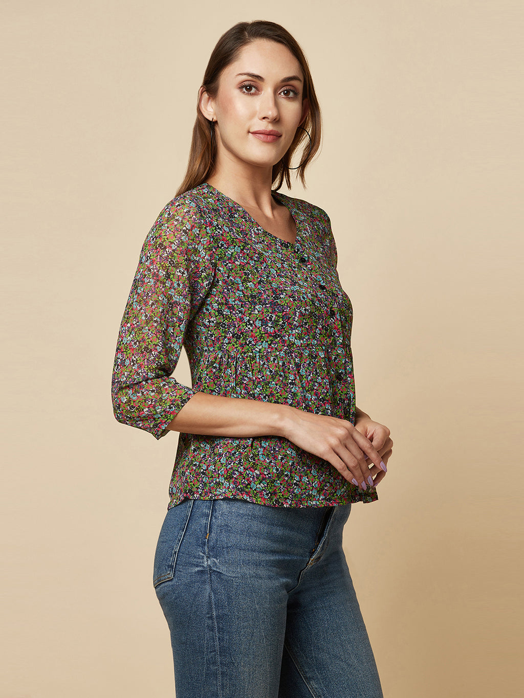 A Green printed top with a front placket and ruched bust line is a stylish and elegant piece of clothing. The top has a simple and classic design with a front placket that adds a touch of sophistication to the outfit. The ruched bust line creates a flattering and feminine look, enhancing the wearer's curves.