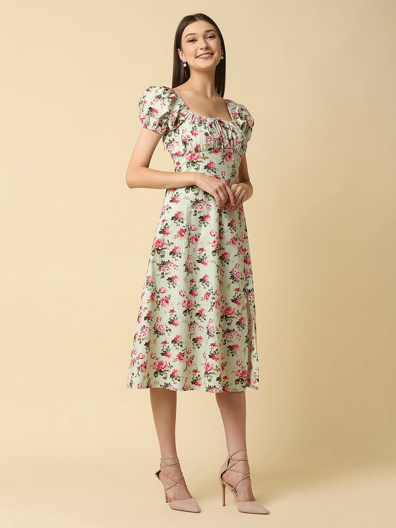 This green floral Printed Women Dress In Cotton is a charming and elegant piece that is sure to catch the eye. Made from soft and breathable cotton fabric, it is perfect for warm weather and will keep you comfortable all day long. The dress features a beautiful floral print in shades of pink, white, and green that adds a pop of color to your wardrobe.  The ruched bust and empire waist create a flattering silhouette that accentuates your curves and adds a feminine touch to the dress. 