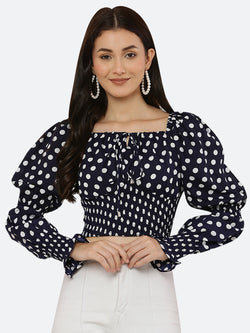 Blue polka dot smocked crop top for women is a trendy and stylish garment that features a fitted and stretchy smocked bodice, with a cropped hem that sits above the waistline. The top is adorned with small polka dots that add a playful and feminine touch.  This type of top is versatile and can be styled in a variety of ways. 
