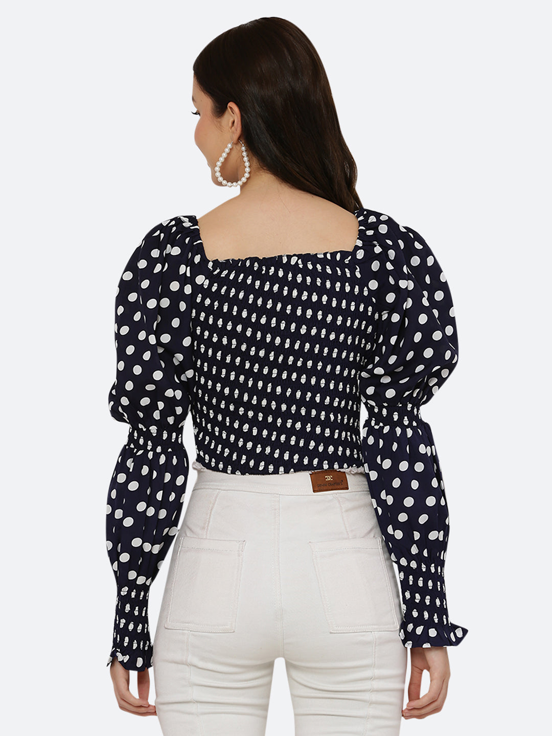 Blue polka dot smocked crop top for women is a trendy and stylish garment that features a fitted and stretchy smocked bodice, with a cropped hem that sits above the waistline. The top is adorned with small polka dots that add a playful and feminine touch.  This type of top is versatile and can be styled in a variety of ways. 