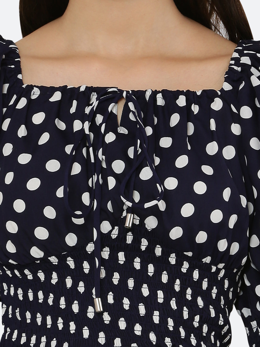 Blue polka dot smocked crop top for women is a trendy and stylish garment that features a fitted and stretchy smocked bodice, with a cropped hem that sits above the waistline. The top is adorned with small polka dots that add a playful and feminine touch.  This type of top is versatile and can be styled in a variety of ways. 