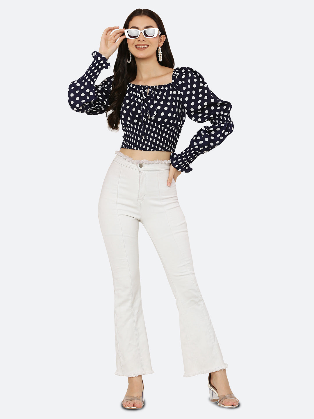Blue polka dot smocked crop top for women is a trendy and stylish garment that features a fitted and stretchy smocked bodice, with a cropped hem that sits above the waistline. The top is adorned with small polka dots that add a playful and feminine touch.  This type of top is versatile and can be styled in a variety of ways. 