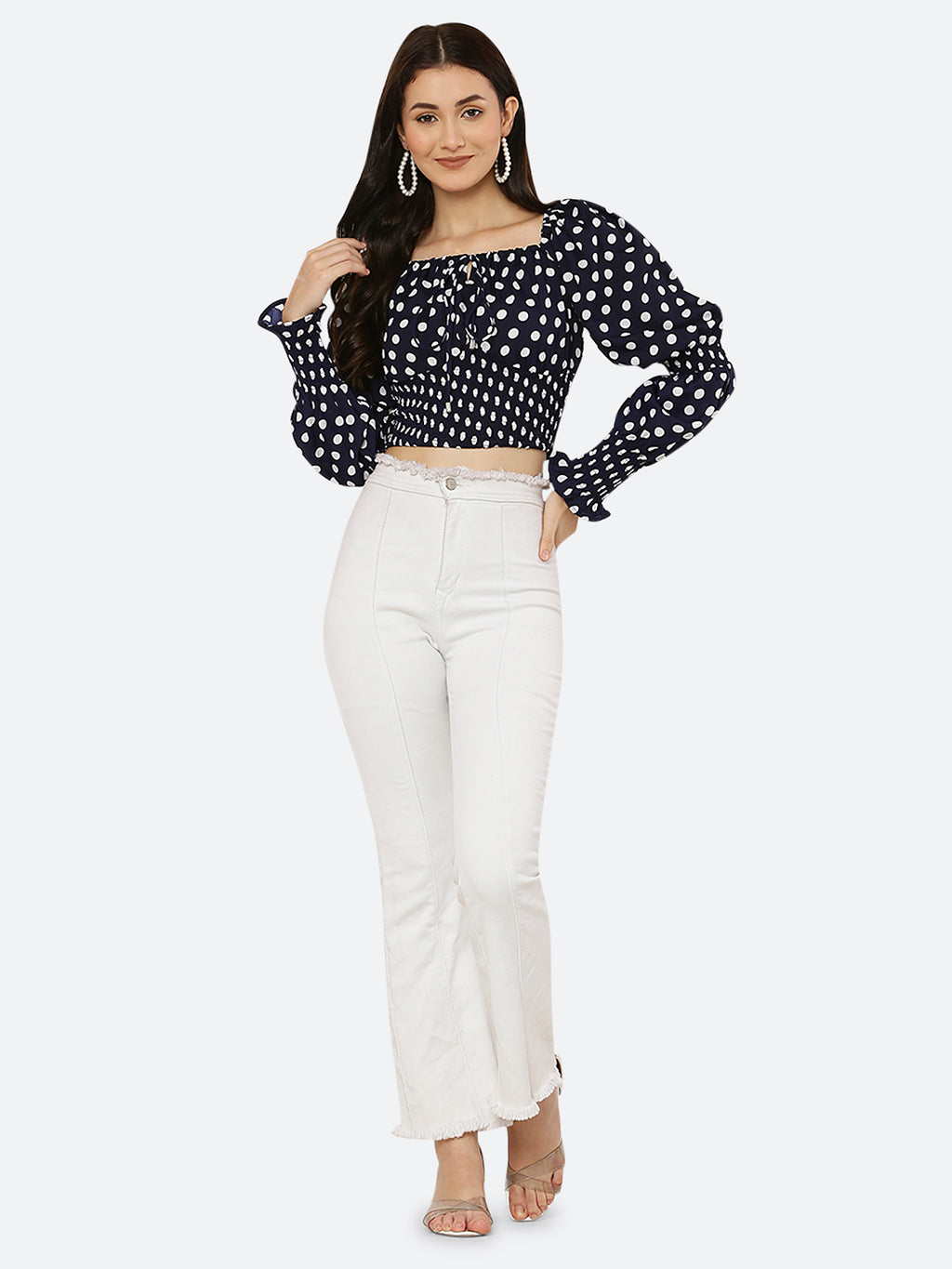 Blue polka dot smocked crop top for women is a trendy and stylish garment that features a fitted and stretchy smocked bodice, with a cropped hem that sits above the waistline. The top is adorned with small polka dots that add a playful and feminine touch.  This type of top is versatile and can be styled in a variety of ways. 