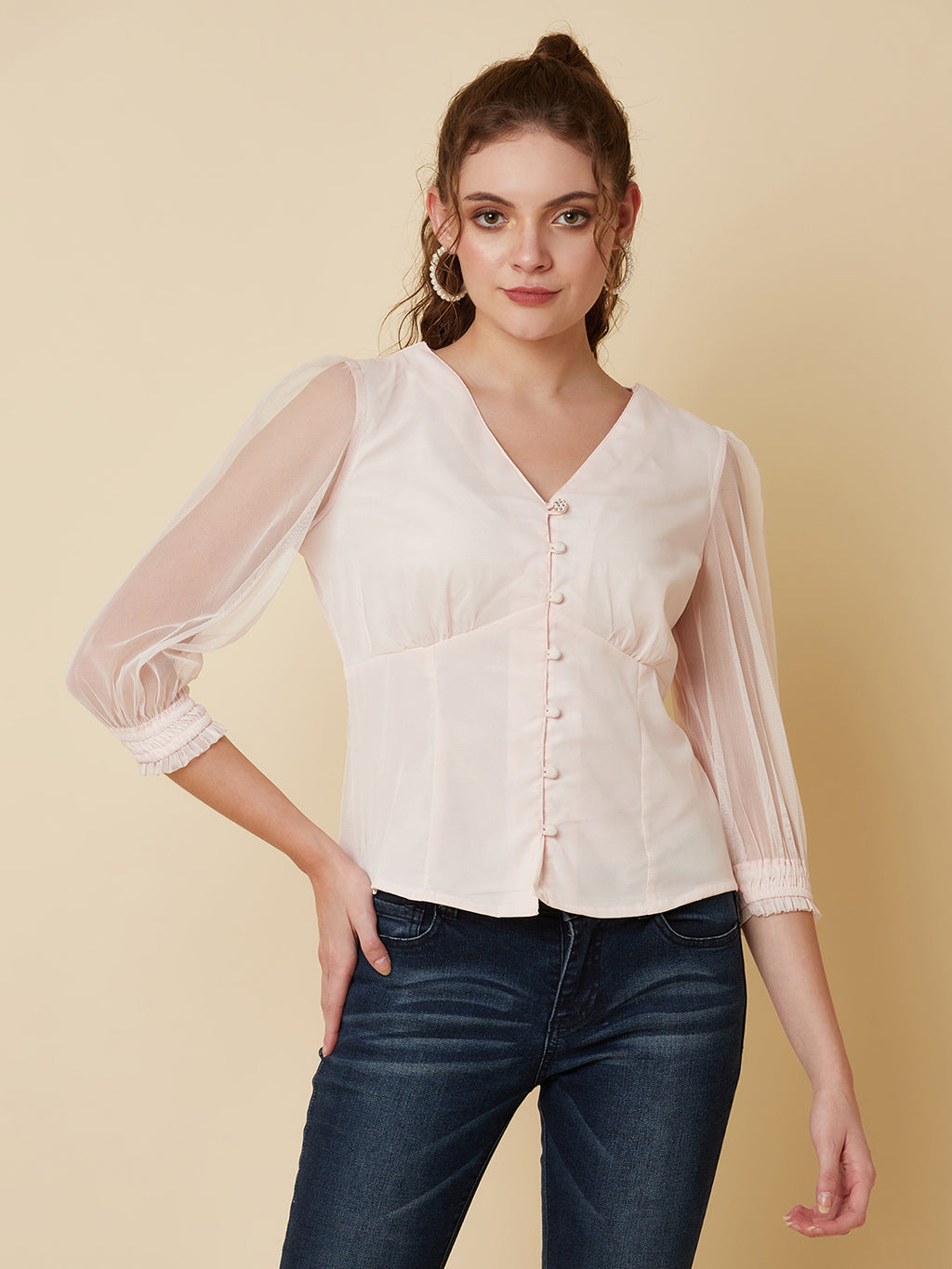 This pink mesh top features a front button closure, allowing for easy wear and a stylish look. The mesh material adds a unique and trendy touch to the piece, while the soft pink color adds a feminine and playful feel.  This top can be dressed up or down, making it a versatile addition to any wardrobe. Pair it with a high waisted skirt for a chic look, or with jeans and sneakers for a more casual vibe.
