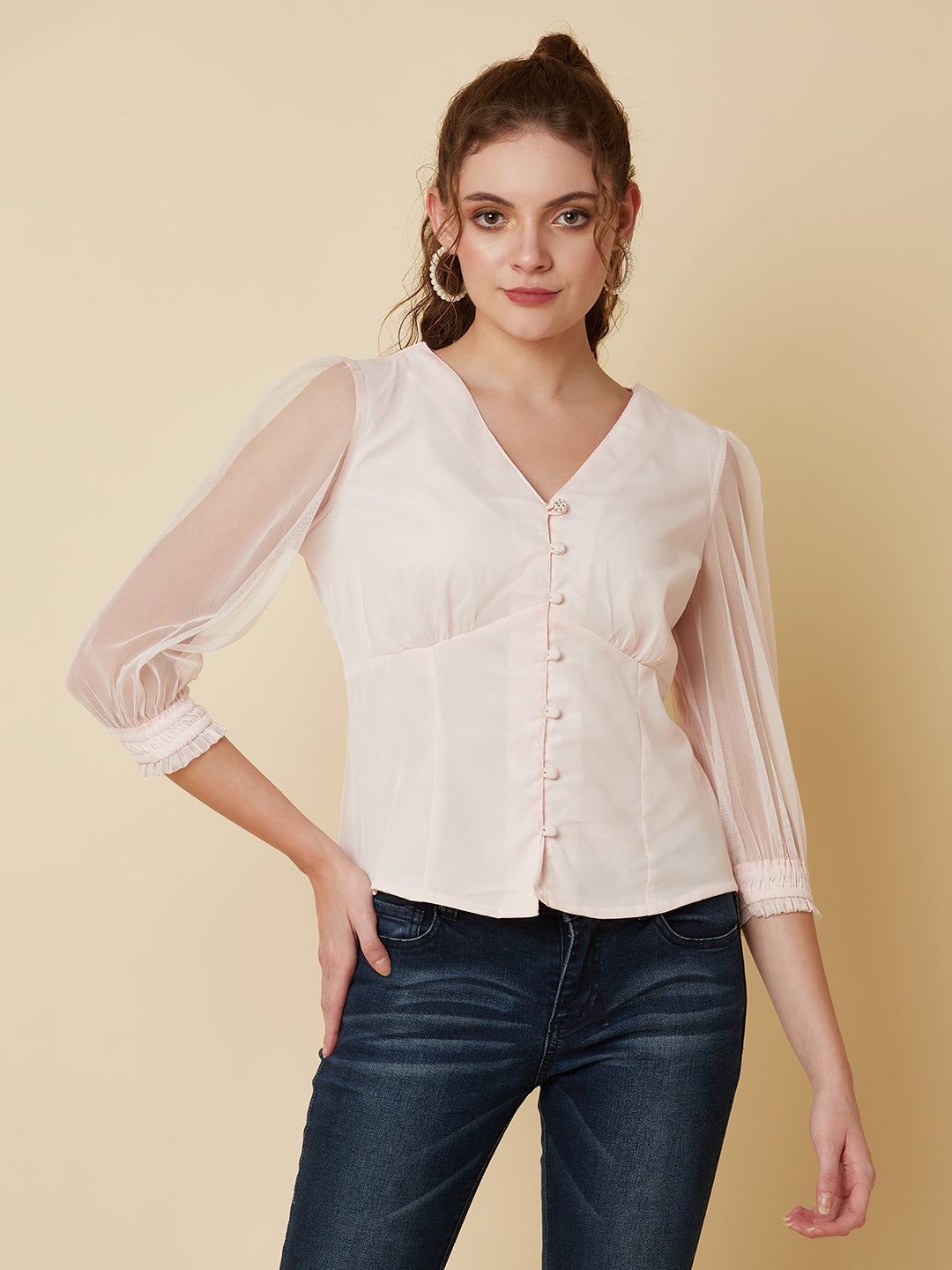 This pink mesh top features a front button closure, allowing for easy wear and a stylish look. The mesh material adds a unique and trendy touch to the piece, while the soft pink color adds a feminine and playful feel.  This top can be dressed up or down, making it a versatile addition to any wardrobe. Pair it with a high waisted skirt for a chic look, or with jeans and sneakers for a more casual vibe.