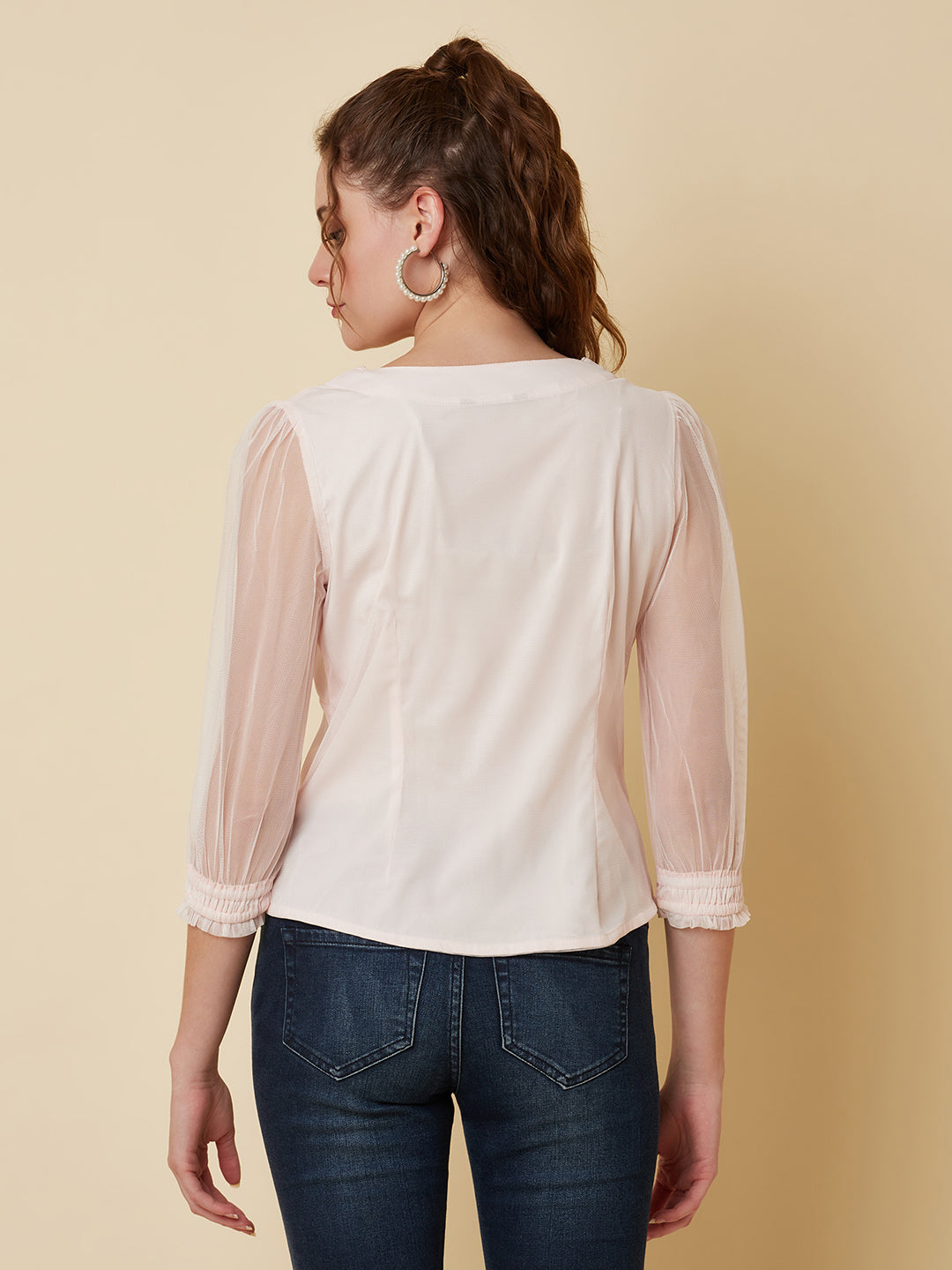 This pink mesh top features a front button closure, allowing for easy wear and a stylish look. The mesh material adds a unique and trendy touch to the piece, while the soft pink color adds a feminine and playful feel.  This top can be dressed up or down, making it a versatile addition to any wardrobe. Pair it with a high waisted skirt for a chic look, or with jeans and sneakers for a more casual vibe.