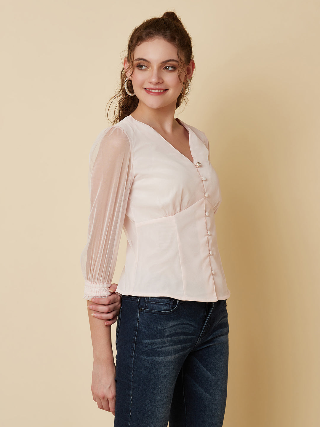 This pink mesh top features a front button closure, allowing for easy wear and a stylish look. The mesh material adds a unique and trendy touch to the piece, while the soft pink color adds a feminine and playful feel.  This top can be dressed up or down, making it a versatile addition to any wardrobe. Pair it with a high waisted skirt for a chic look, or with jeans and sneakers for a more casual vibe.