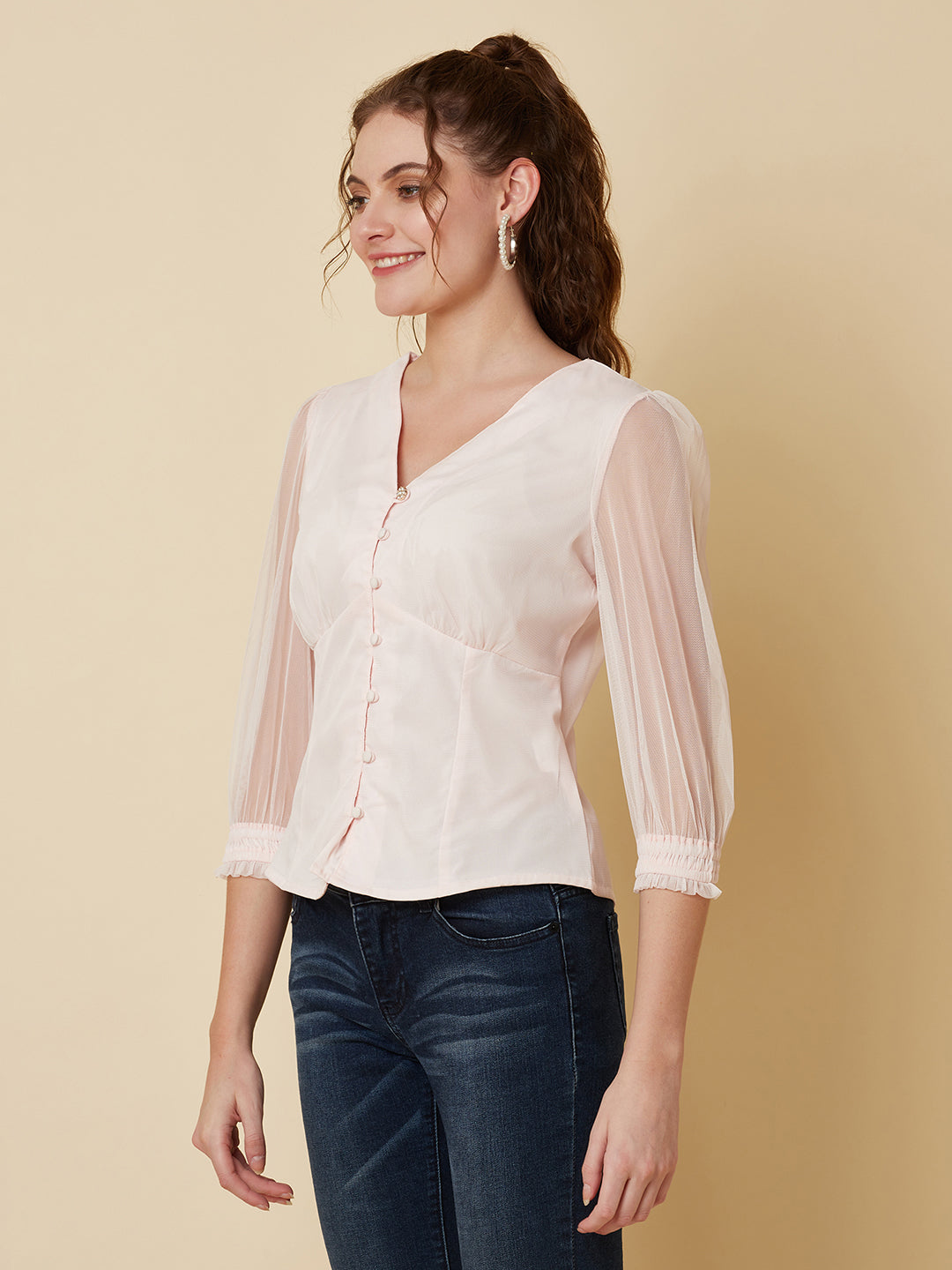 This pink mesh top features a front button closure, allowing for easy wear and a stylish look. The mesh material adds a unique and trendy touch to the piece, while the soft pink color adds a feminine and playful feel.  This top can be dressed up or down, making it a versatile addition to any wardrobe. Pair it with a high waisted skirt for a chic look, or with jeans and sneakers for a more casual vibe.