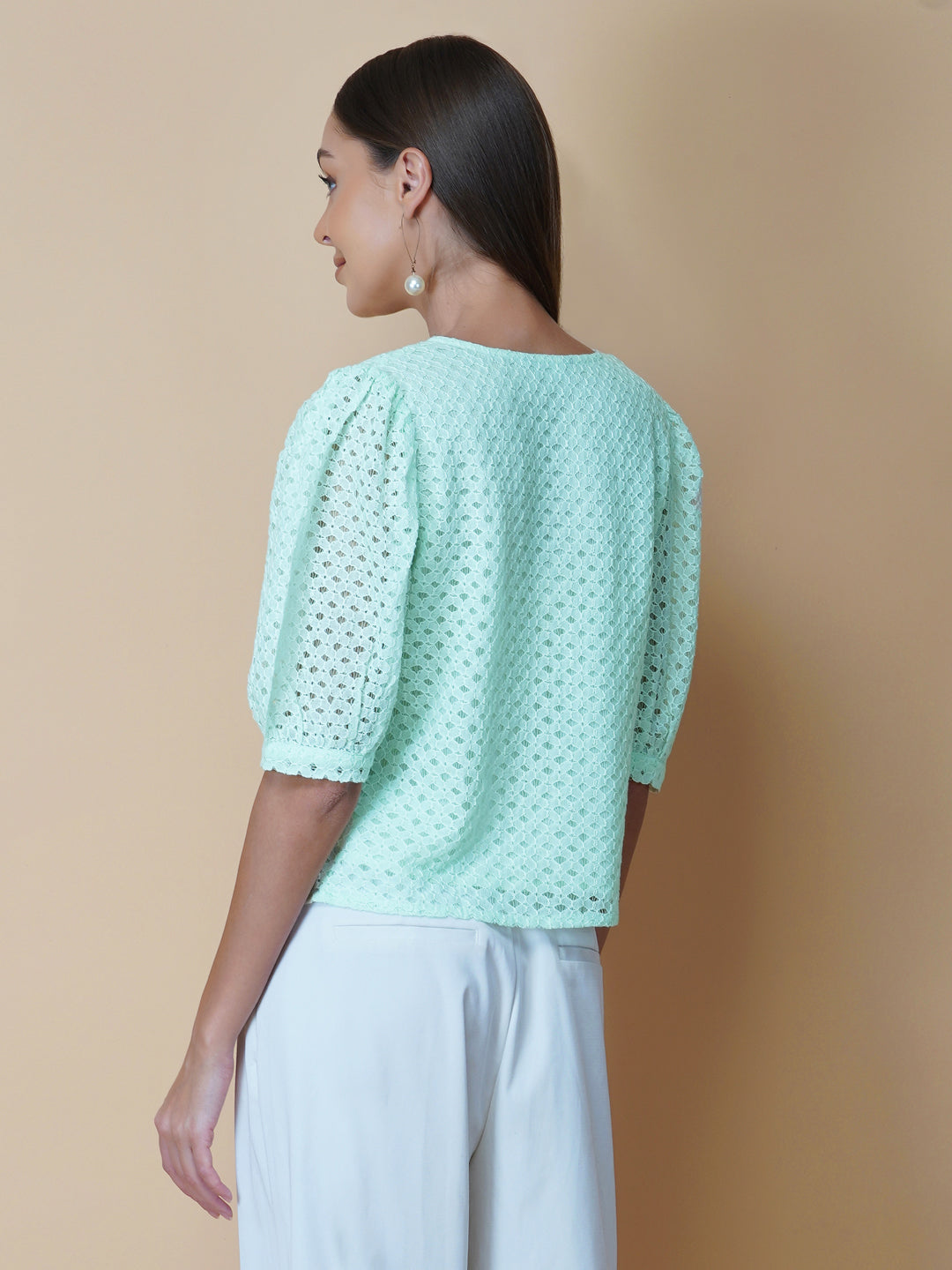 The Green Color Jacquard Mesh Women Top is a versatile and stylish piece of clothing that is perfect for both formal and casual occasions. The top features a classic V-neck design that is flattering for all body types, and it is adorned with a row of front buttons that add a touch of elegance and sophistication to the overall look.  Made from good-quality jacquard mesh fabric, this top is lightweight, breathable, and comfortable to wear all day long. 