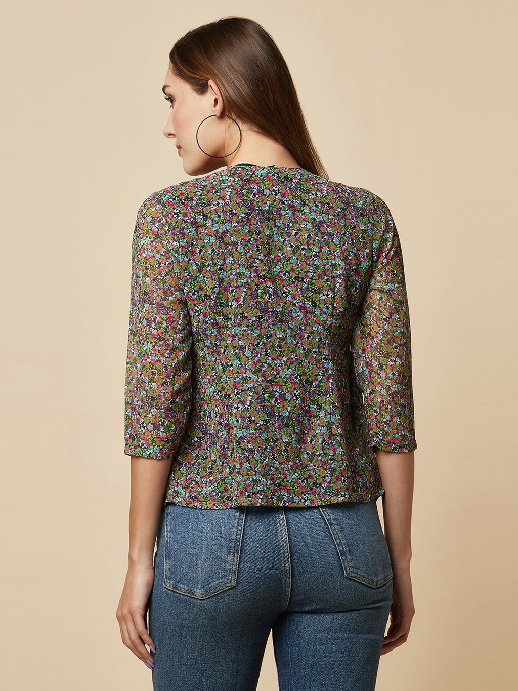 A Green printed top with a front placket and ruched bust line is a stylish and elegant piece of clothing. The top has a simple and classic design with a front placket that adds a touch of sophistication to the outfit. The ruched bust line creates a flattering and feminine look, enhancing the wearer's curves.