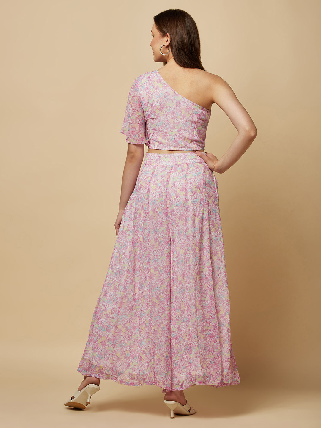 This fashionable co-ord set features a stunning purple floral print, making it the perfect addition to any fashion-forward woman's wardrobe. The set includes a trendy one-shoulder crop top and a pair of flowing palazzo pants.  The top is designed with a single shoulder strap, which adds an edgy and modern touch to the overall look. It also features a fitted bodice, which flatters the silhouette and accentuates the curves.