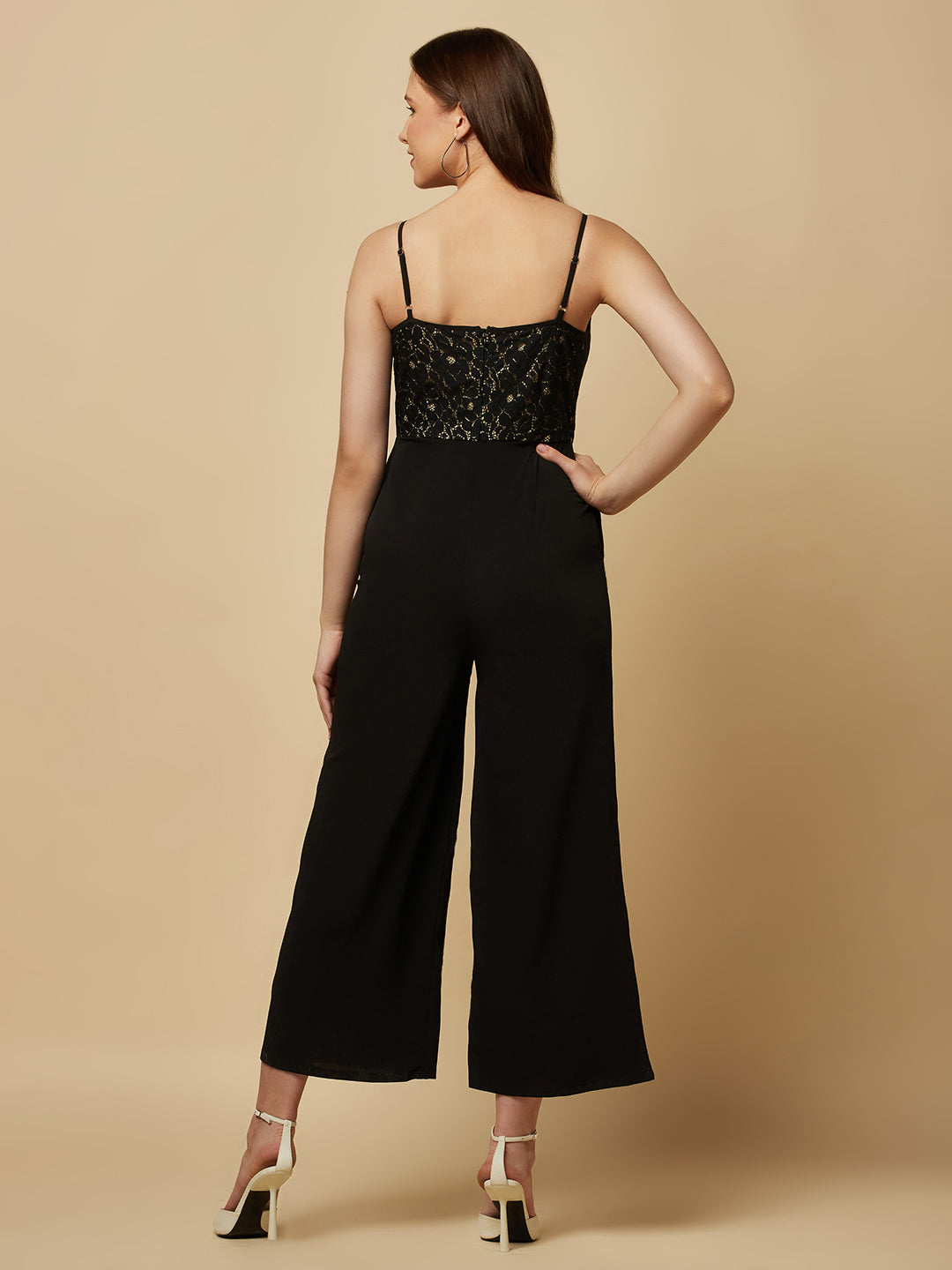 Black cowl neck women jumpsuit with jacquard mesh body and crepe pants is a fashionable piece of clothing that is both elegant and comfortable. The cowl neck provides a flattering neckline that is both feminine and sophisticated.  The jacquard mesh body adds a touch of glamour and texture to the piece, while the crepe pants provide a smooth and comfortable fit.