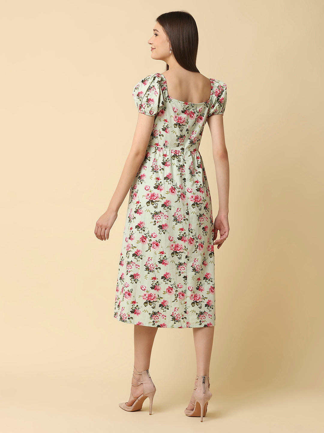 This green floral Printed Women Dress In Cotton is a charming and elegant piece that is sure to catch the eye. Made from soft and breathable cotton fabric, it is perfect for warm weather and will keep you comfortable all day long. The dress features a beautiful floral print in shades of pink, white, and green that adds a pop of color to your wardrobe.  The ruched bust and empire waist create a flattering silhouette that accentuates your curves and adds a feminine touch to the dress. 