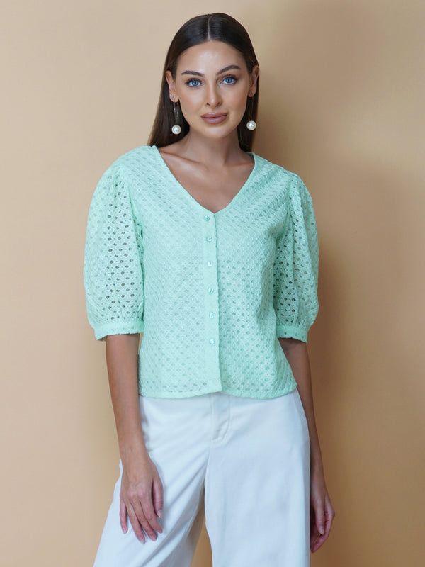 The Green Color Jacquard Mesh Women Top is a versatile and stylish piece of clothing that is perfect for both formal and casual occasions. The top features a classic V-neck design that is flattering for all body types, and it is adorned with a row of front buttons that add a touch of elegance and sophistication to the overall look.  Made from good-quality jacquard mesh fabric, this top is lightweight, breathable, and comfortable to wear all day long. 