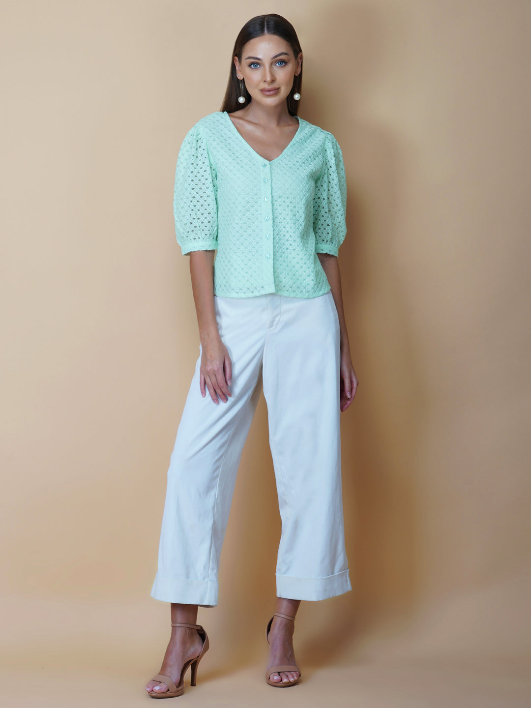 The Green Color Jacquard Mesh Women Top is a versatile and stylish piece of clothing that is perfect for both formal and casual occasions. The top features a classic V-neck design that is flattering for all body types, and it is adorned with a row of front buttons that add a touch of elegance and sophistication to the overall look.  Made from good-quality jacquard mesh fabric, this top is lightweight, breathable, and comfortable to wear all day long. 