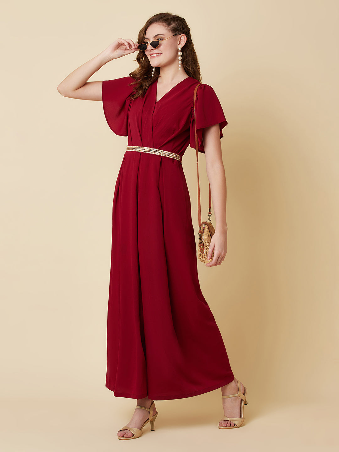 This Burgundy Color Solid Pleated Jumpsuit is perfect for any occasion, whether it be a day out shopping or a night out with friends.The pleated design adds a touch of sophistication and the wide leg pants are comfortable and easy to wear.