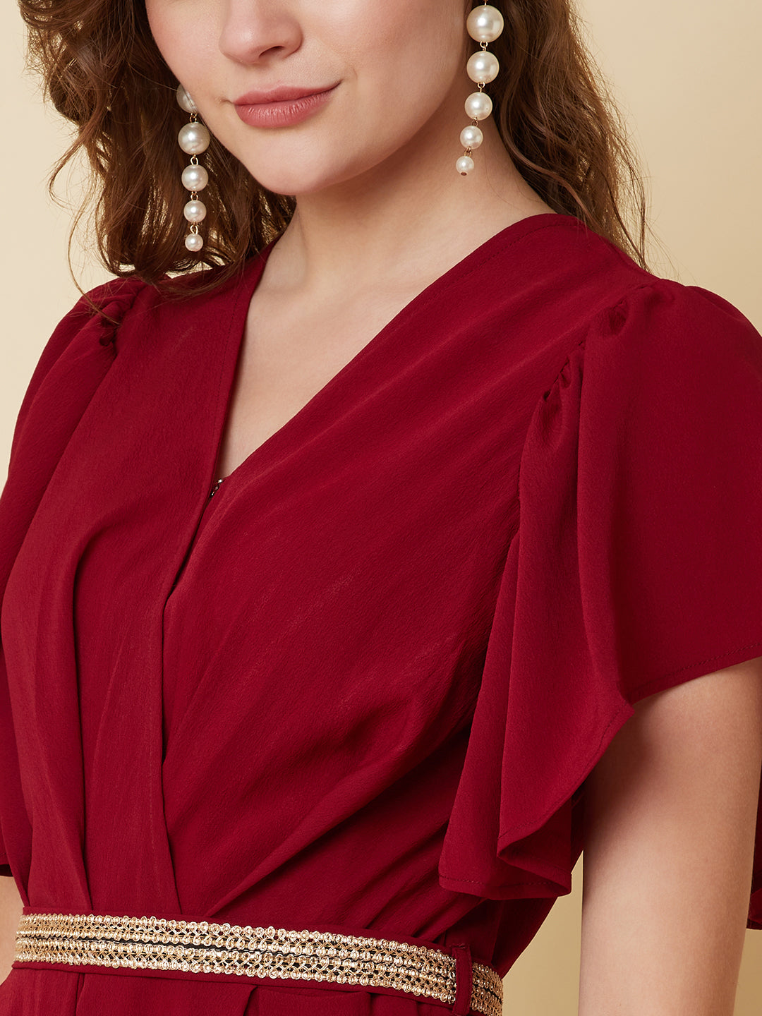 This Burgundy Color Solid Pleated Jumpsuit is perfect for any occasion, whether it be a day out shopping or a night out with friends.The pleated design adds a touch of sophistication and the wide leg pants are comfortable and easy to wear.