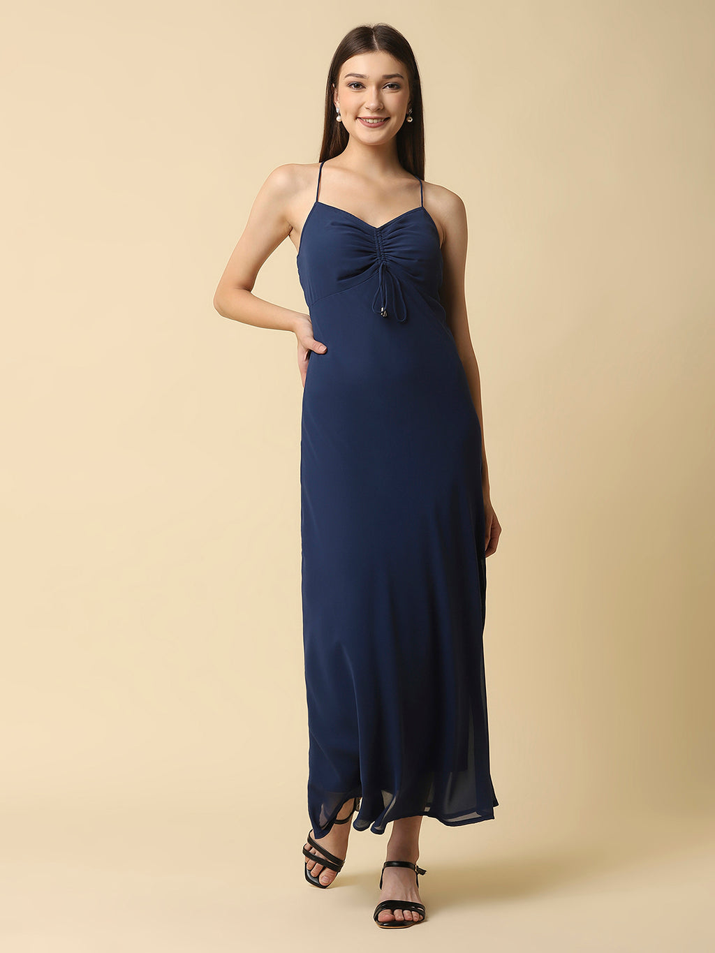 This solid maxi dress features a ruched bust and noodle straps, making it a perfect summer staple. The ruched bust adds a touch of femininity and the noodle straps ensure a comfortable fit. The maxi length makes it great for formal or casual occasions.