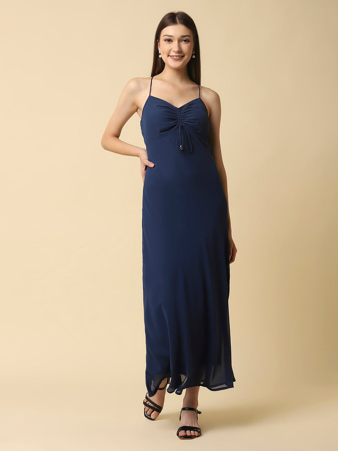 This solid maxi dress features a ruched bust and noodle straps, making it a perfect summer staple. The ruched bust adds a touch of femininity and the noodle straps ensure a comfortable fit. The maxi length makes it great for formal or casual occasions.