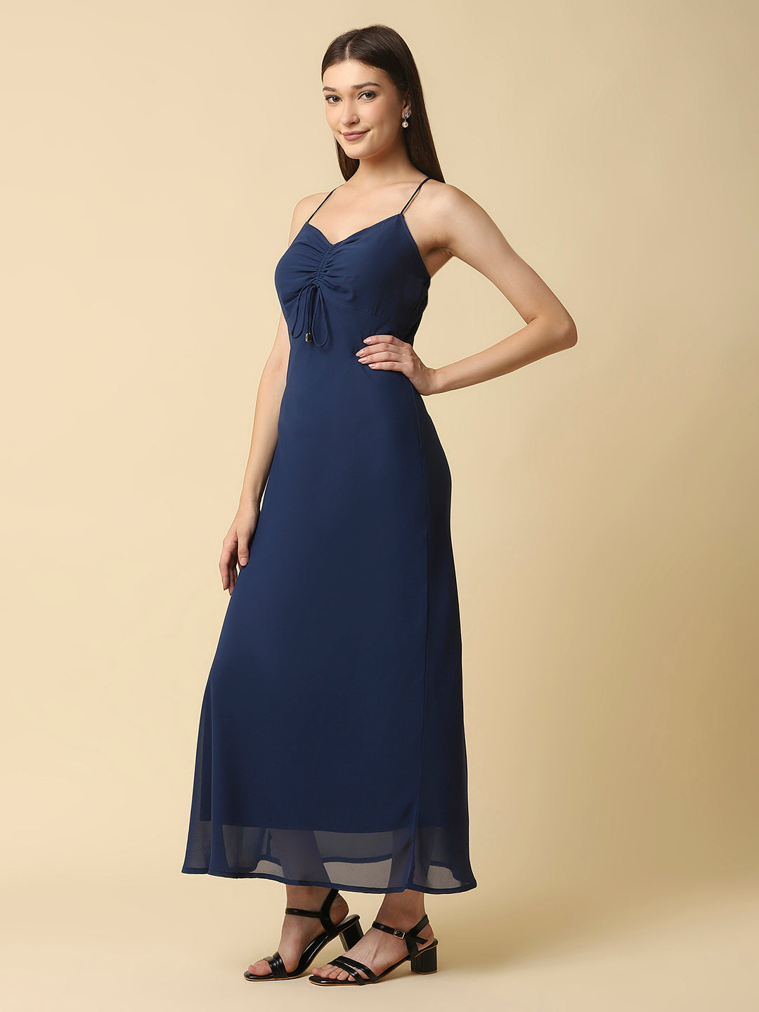 This solid maxi dress features a ruched bust and noodle straps, making it a perfect summer staple. The ruched bust adds a touch of femininity and the noodle straps ensure a comfortable fit. The maxi length makes it great for formal or casual occasions.