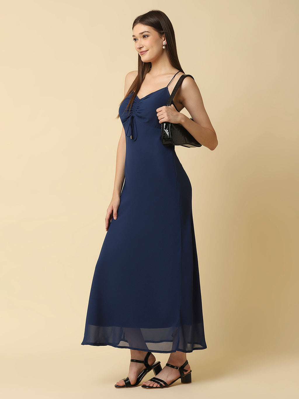 This solid maxi dress features a ruched bust and noodle straps, making it a perfect summer staple. The ruched bust adds a touch of femininity and the noodle straps ensure a comfortable fit. The maxi length makes it great for formal or casual occasions.