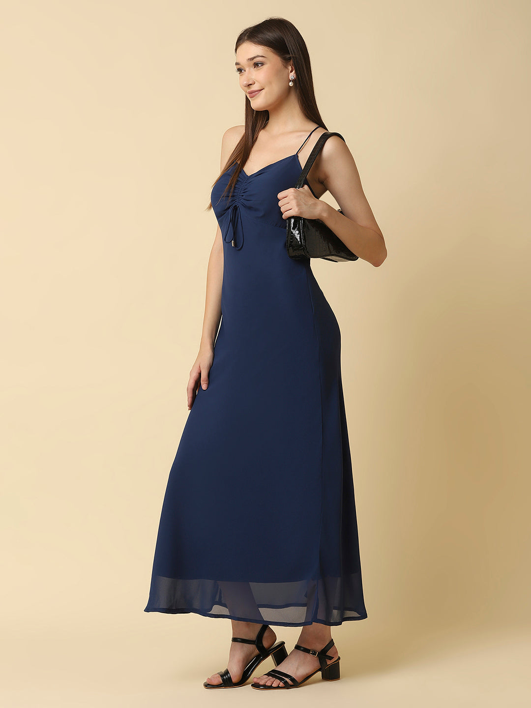 This solid maxi dress features a ruched bust and noodle straps, making it a perfect summer staple. The ruched bust adds a touch of femininity and the noodle straps ensure a comfortable fit. The maxi length makes it great for formal or casual occasions.