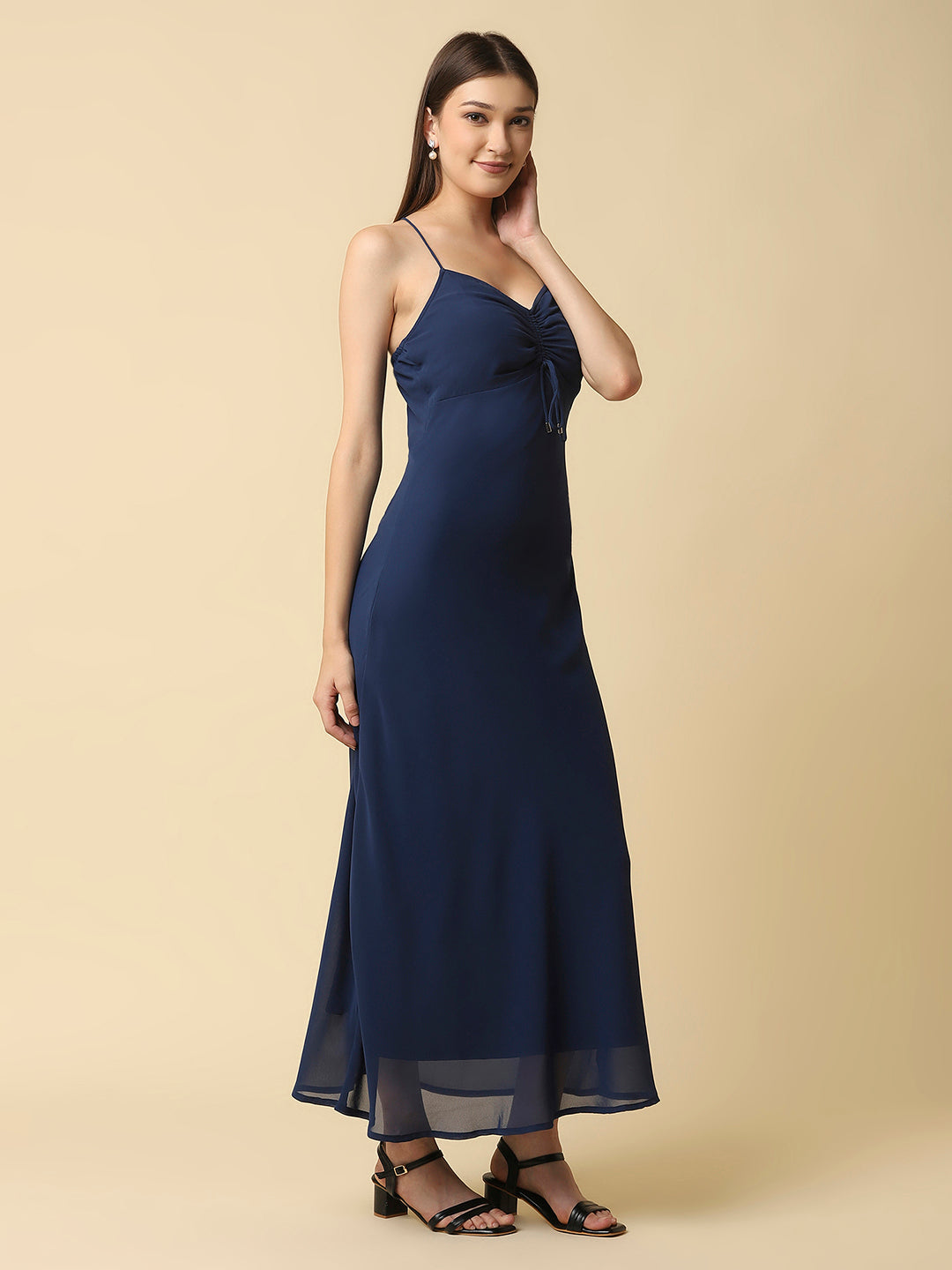 This solid maxi dress features a ruched bust and noodle straps, making it a perfect summer staple. The ruched bust adds a touch of femininity and the noodle straps ensure a comfortable fit. The maxi length makes it great for formal or casual occasions.