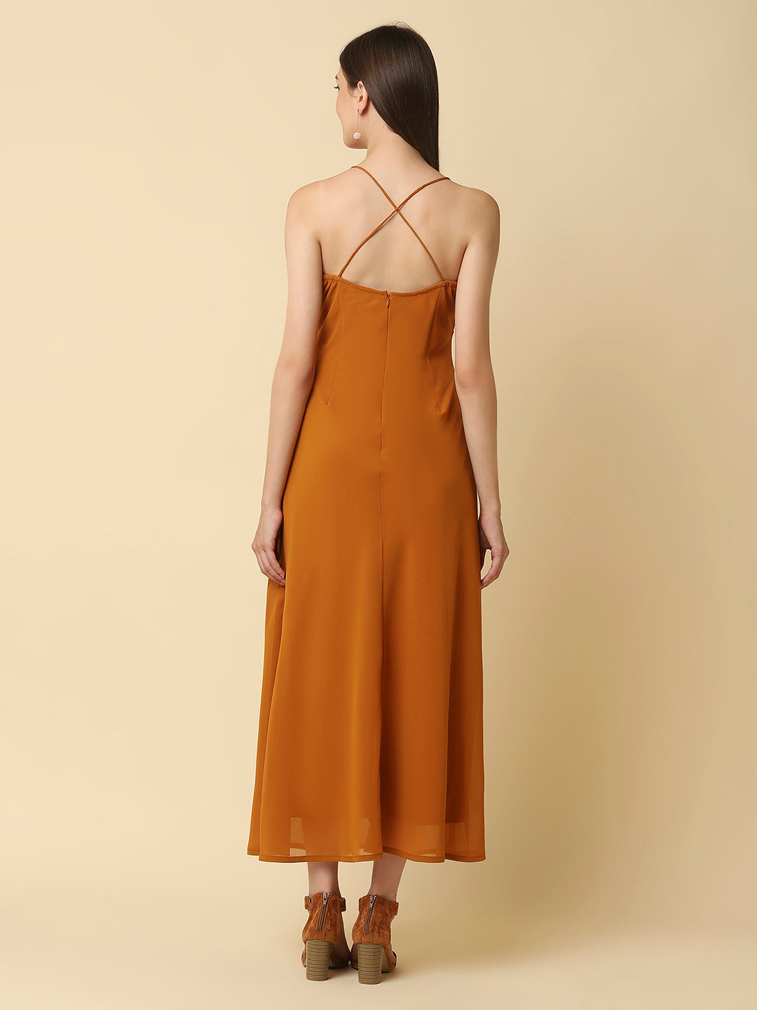 This solid maxi dress features a ruched bust and noodle straps, making it a perfect summer staple. The ruched bust adds a touch of femininity and the noodle straps ensure a comfortable fit. The maxi length makes it great for formal or casual occasions.