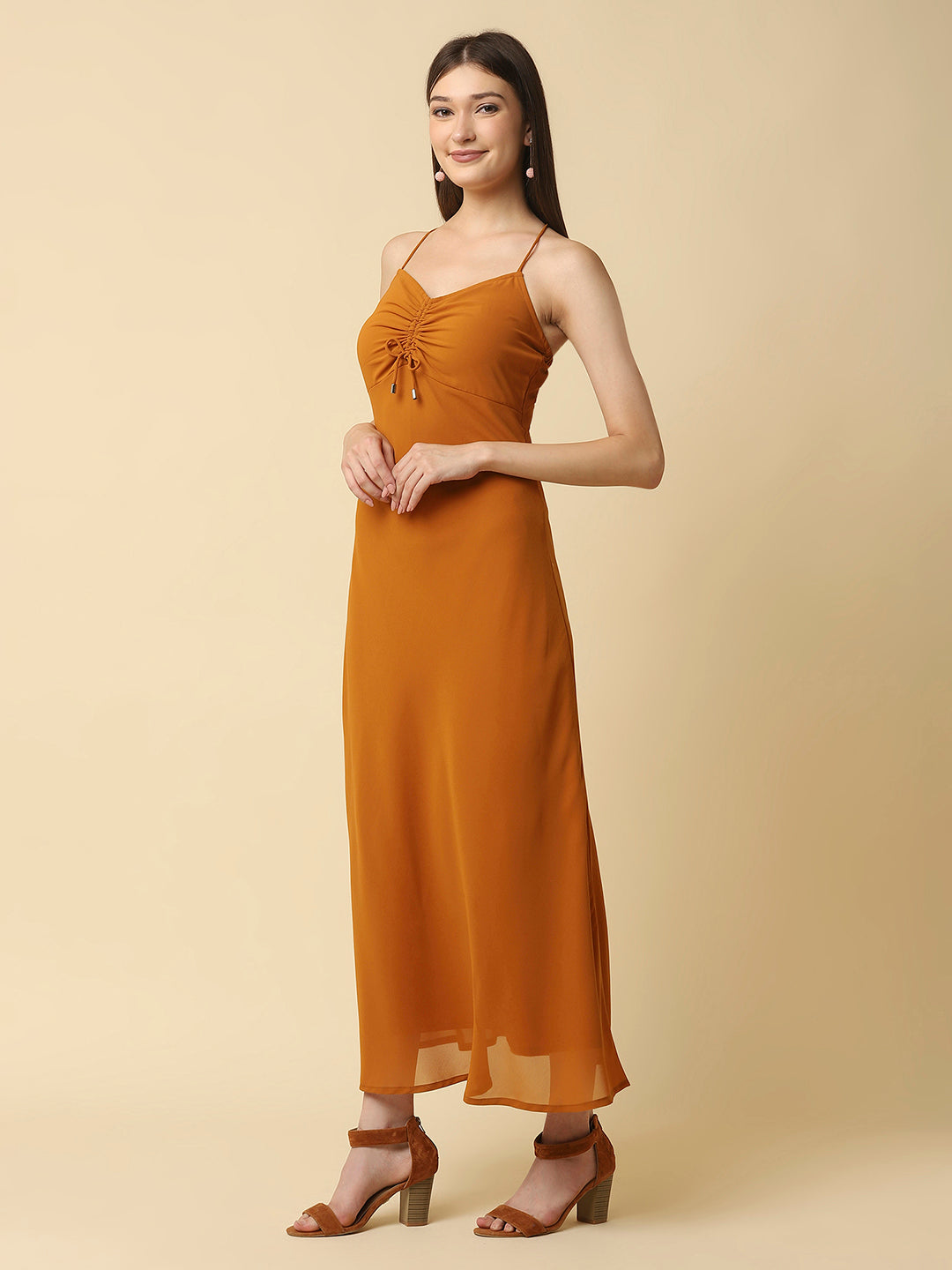 This solid maxi dress features a ruched bust and noodle straps, making it a perfect summer staple. The ruched bust adds a touch of femininity and the noodle straps ensure a comfortable fit. The maxi length makes it great for formal or casual occasions.
