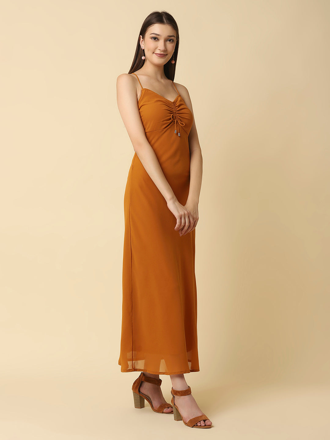 This solid maxi dress features a ruched bust and noodle straps, making it a perfect summer staple. The ruched bust adds a touch of femininity and the noodle straps ensure a comfortable fit. The maxi length makes it great for formal or casual occasions.