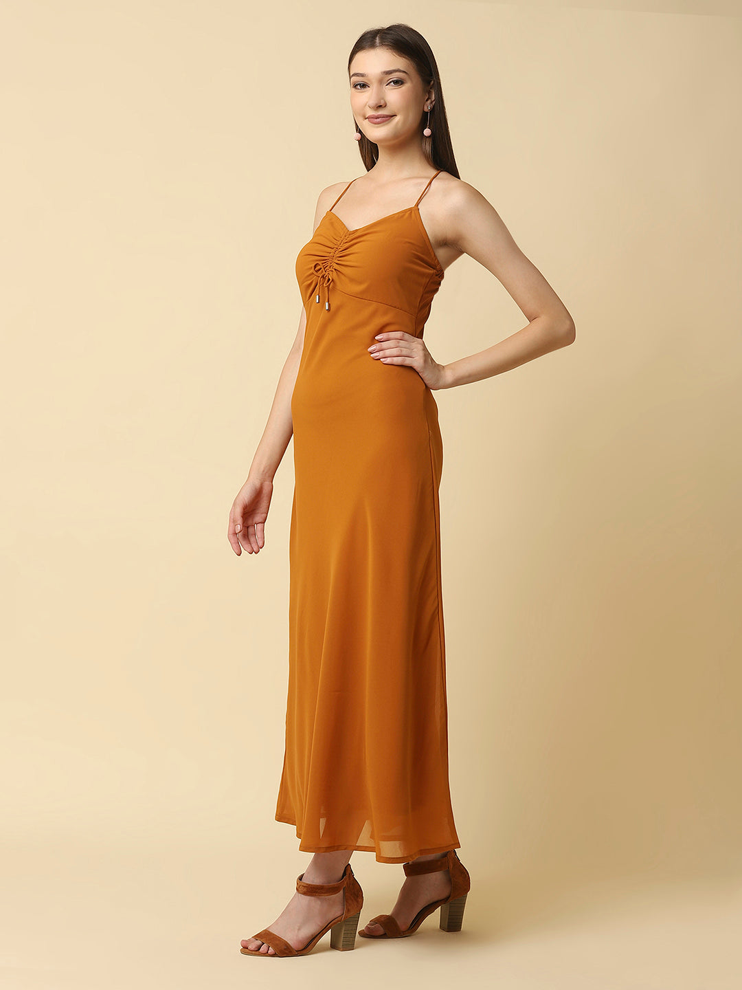 This solid maxi dress features a ruched bust and noodle straps, making it a perfect summer staple. The ruched bust adds a touch of femininity and the noodle straps ensure a comfortable fit. The maxi length makes it great for formal or casual occasions.