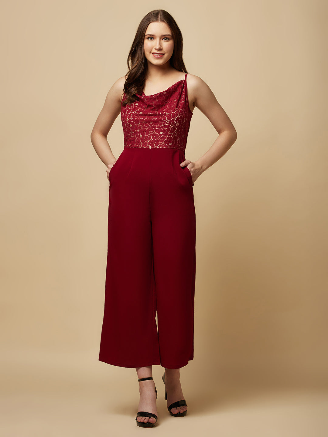 Burgundy cowl neck women jumpsuit with jacquard mesh body and crepe pants is a fashionable piece of clothing that is both elegant and comfortable. The cowl neck provides a flattering neckline that is both feminine and sophisticated.  The jacquard mesh body adds a touch of glamour and texture to the piece, while the crepe pants provide a smooth and comfortable fit.