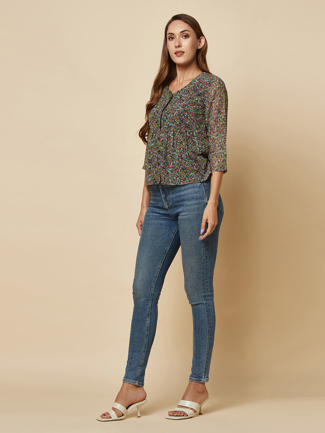 A Green printed top with a front placket and ruched bust line is a stylish and elegant piece of clothing. The top has a simple and classic design with a front placket that adds a touch of sophistication to the outfit. The ruched bust line creates a flattering and feminine look, enhancing the wearer's curves.