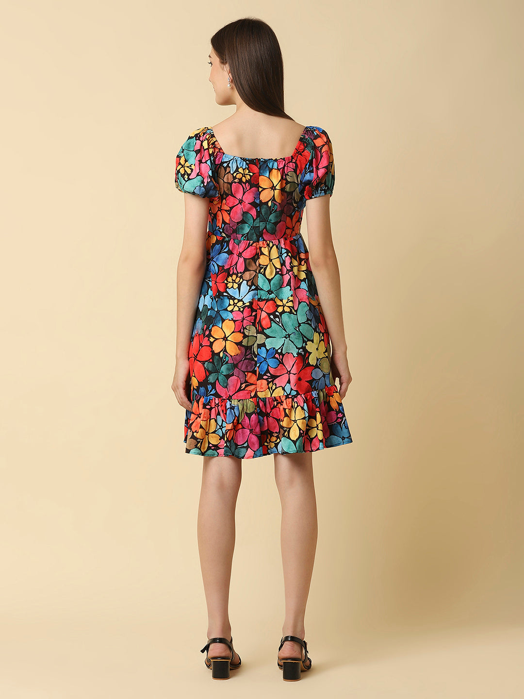 A floral printed empire waist short dress with gathered sleeves is a stylish and feminine dress that would be perfect for a variety of occasions. The empire waist style of the dress is defined by a high waistline that sits just below the bust, giving the dress a flowy and relaxed fit.