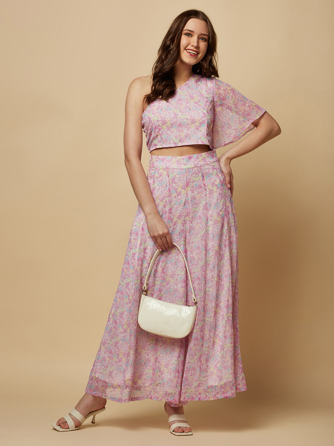 This fashionable co-ord set features a stunning purple floral print, making it the perfect addition to any fashion-forward woman's wardrobe. The set includes a trendy one-shoulder crop top and a pair of flowing palazzo pants.  The top is designed with a single shoulder strap, which adds an edgy and modern touch to the overall look. It also features a fitted bodice, which flatters the silhouette and accentuates the curves.