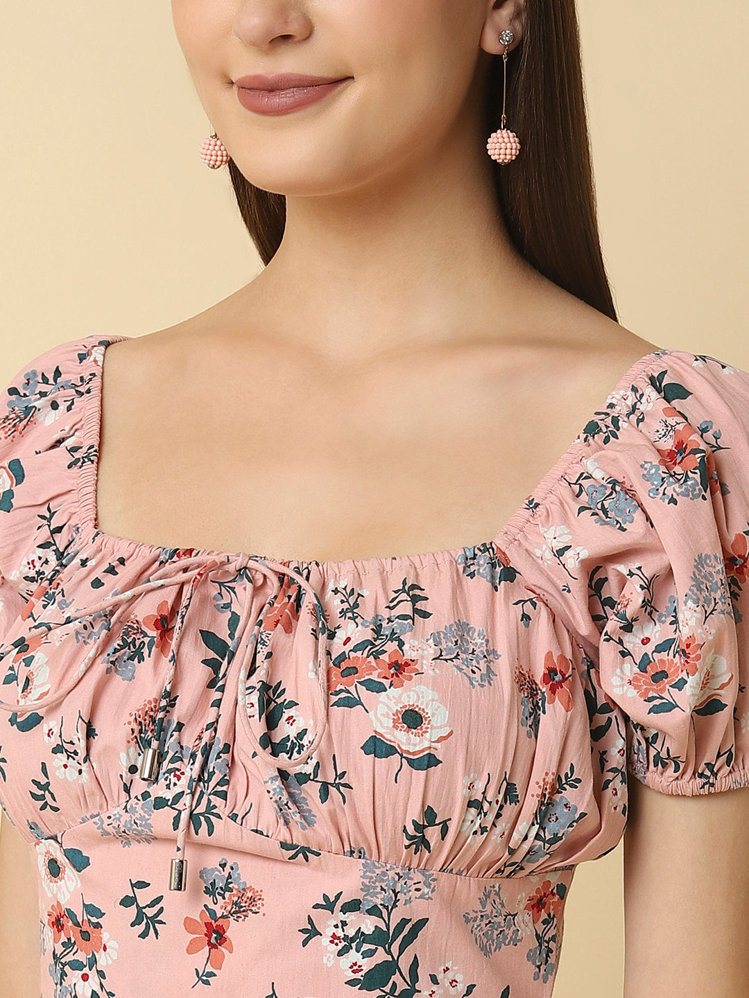 This Pink Floral Printed Women Dress In Cotton is a charming and elegant piece that is sure to catch the eye. Made from soft and breathable cotton fabric, it is perfect for warm weather and will keep you comfortable all day long. The dress features a beautiful floral print in shades of pink, white, and green that adds a pop of color to your wardrobe.
