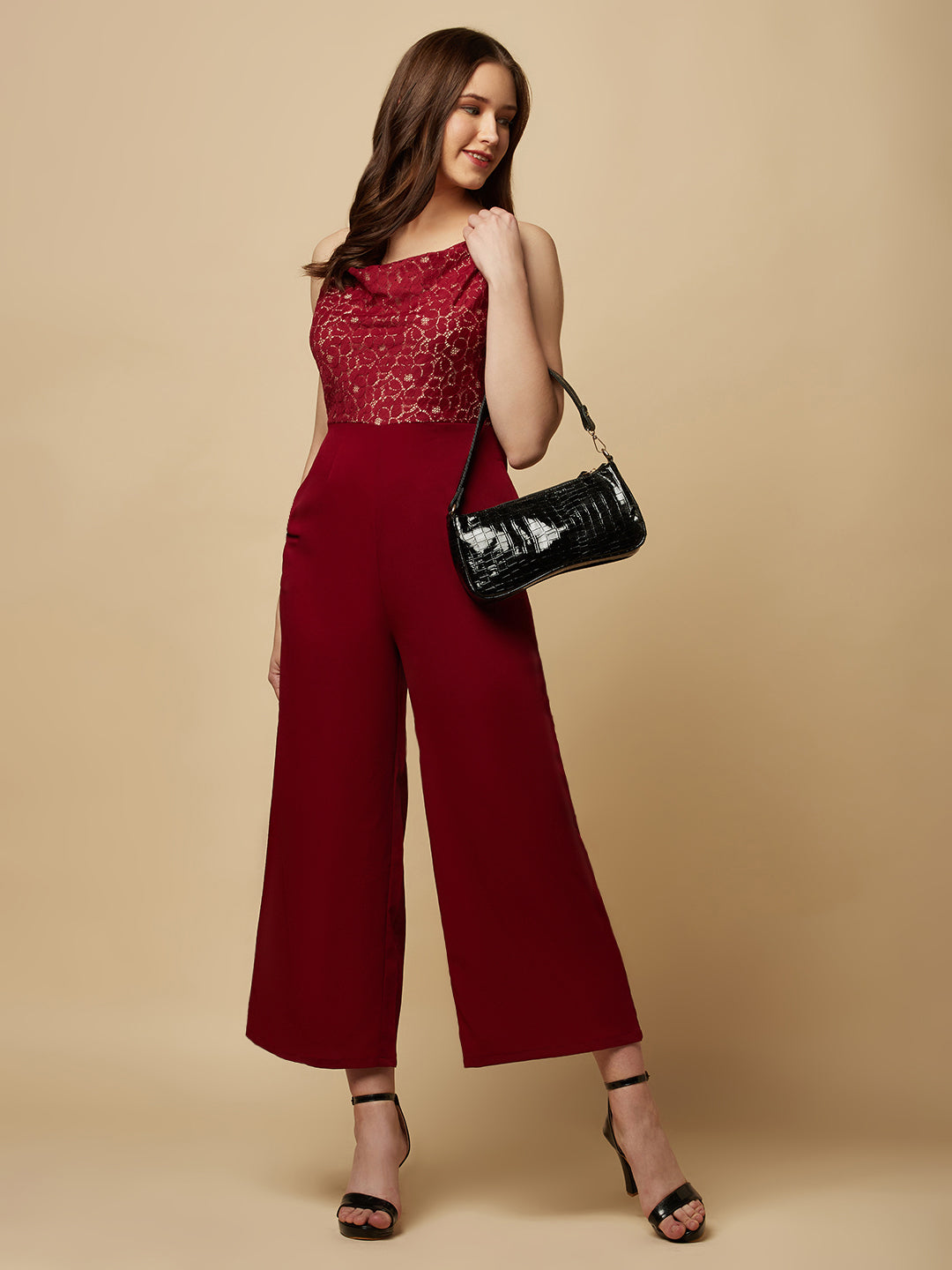 Burgundy cowl neck women jumpsuit with jacquard mesh body and crepe pants is a fashionable piece of clothing that is both elegant and comfortable. The cowl neck provides a flattering neckline that is both feminine and sophisticated.  The jacquard mesh body adds a touch of glamour and texture to the piece, while the crepe pants provide a smooth and comfortable fit.
