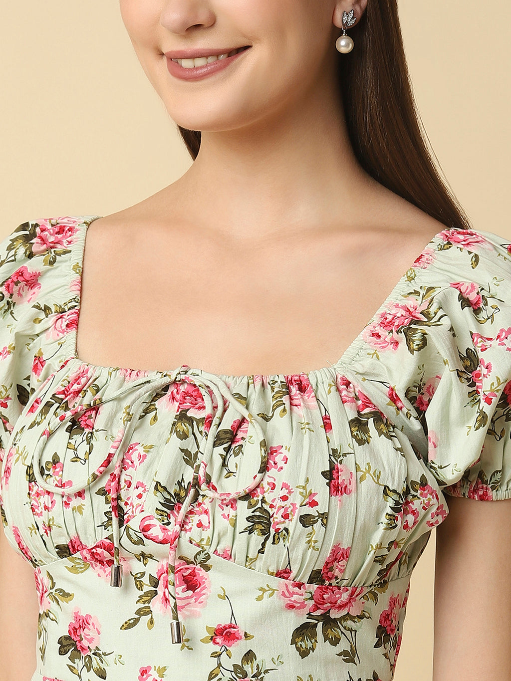 This green floral Printed Women Dress In Cotton is a charming and elegant piece that is sure to catch the eye. Made from soft and breathable cotton fabric, it is perfect for warm weather and will keep you comfortable all day long. The dress features a beautiful floral print in shades of pink, white, and green that adds a pop of color to your wardrobe.  The ruched bust and empire waist create a flattering silhouette that accentuates your curves and adds a feminine touch to the dress. 