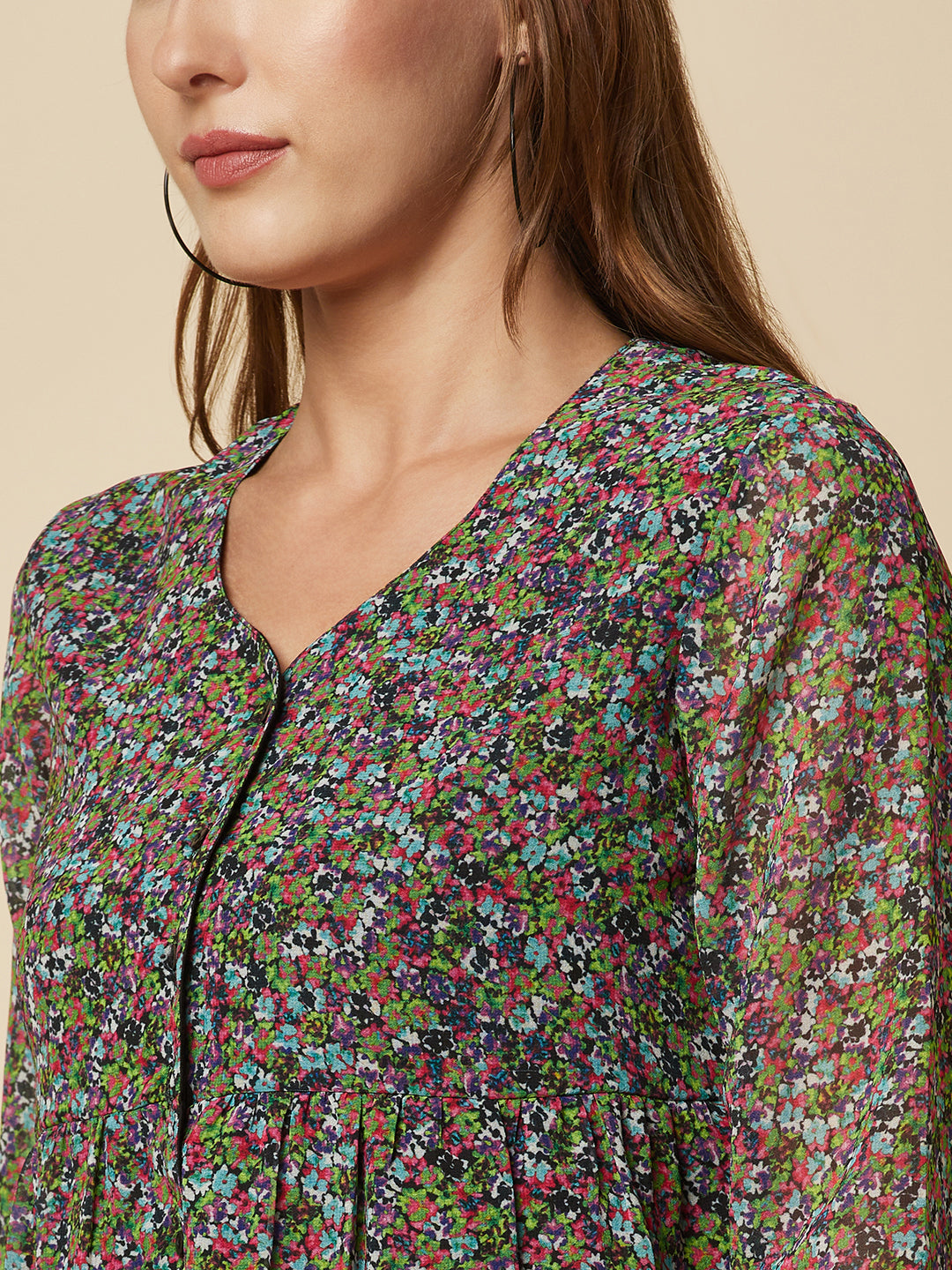 A Green printed top with a front placket and ruched bust line is a stylish and elegant piece of clothing. The top has a simple and classic design with a front placket that adds a touch of sophistication to the outfit. The ruched bust line creates a flattering and feminine look, enhancing the wearer's curves.