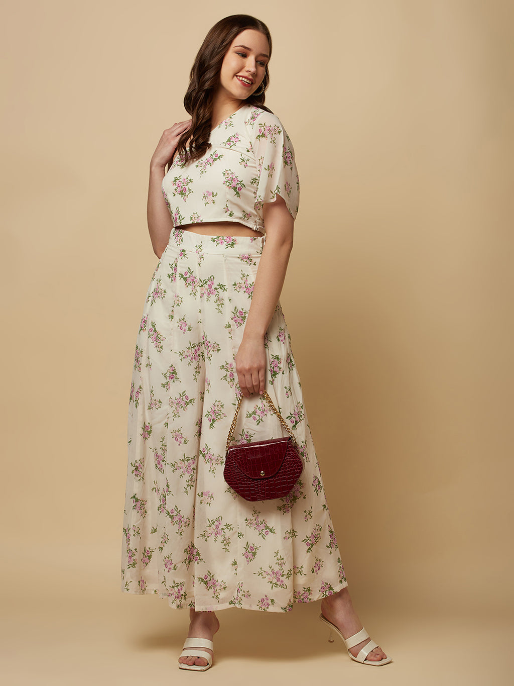 The White Floral Printed Palazzo With One Shoulder Crop Top Co-ords is a stylish and elegant outfit designed for women. This set features a white palazzo pant and a one-shoulder crop top, both adorned with a beautiful floral print in shades of pink, white, and green. The palazzo pants are made of a lightweight and breathable fabric that flows elegantly as you move, providing both comfort and style. 