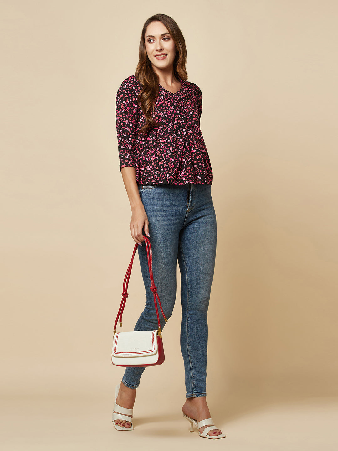 A pink floral printed top with a front placket and ruched bust line is a stylish and elegant piece of clothing. The top has a simple and classic design with a front placket that adds a touch of sophistication to the outfit. The ruched bust line creates a flattering and feminine look, enhancing the wearer's curves. 