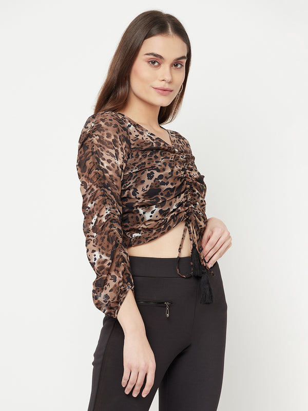 An animal printed ruched crop top for women is a trendy and stylish garment that can add a bold statement to your wardrobe. The animal print adds a wild touch to the design, while the ruched detailing creates a flattering and feminine silhouette. The crop top is perfect for a night out or a casual day look, depending on how you style it.