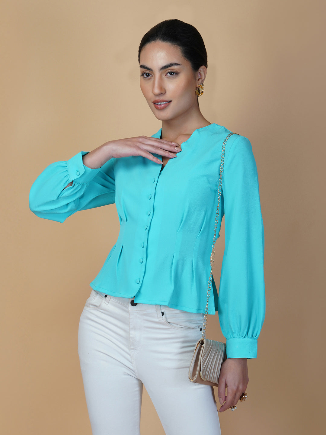 Turquoise color waist pleated women's top with full sleeves is a stylish and fashionable choice for women who want to add some color and texture to their wardrobe. Turquoise is a vibrant and eye-catching color that can help you stand out in a crowd, while the waist pleats add a unique and flattering touch to the design.
