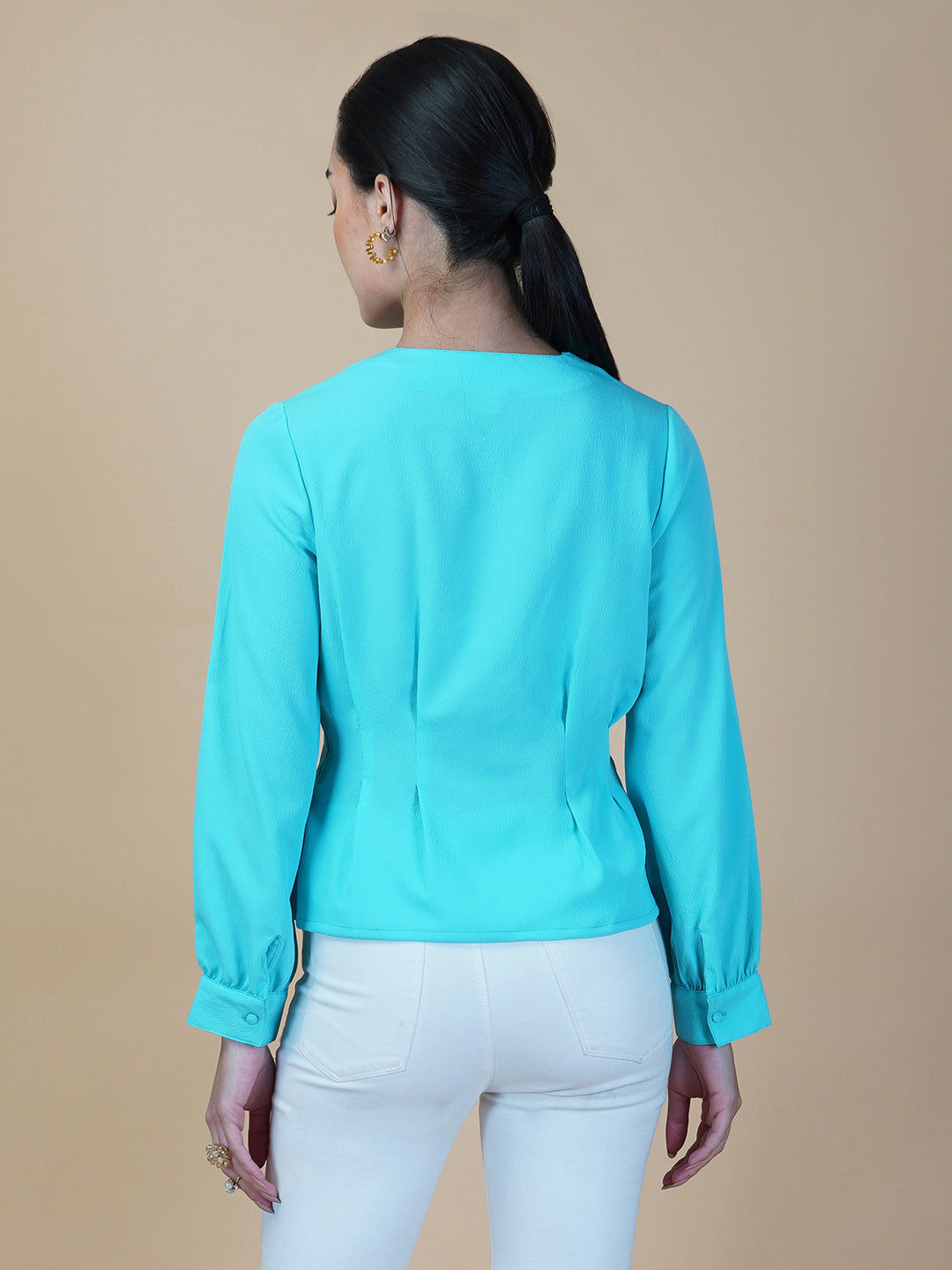 Turquoise color waist pleated women's top with full sleeves is a stylish and fashionable choice for women who want to add some color and texture to their wardrobe. Turquoise is a vibrant and eye-catching color that can help you stand out in a crowd, while the waist pleats add a unique and flattering touch to the design.